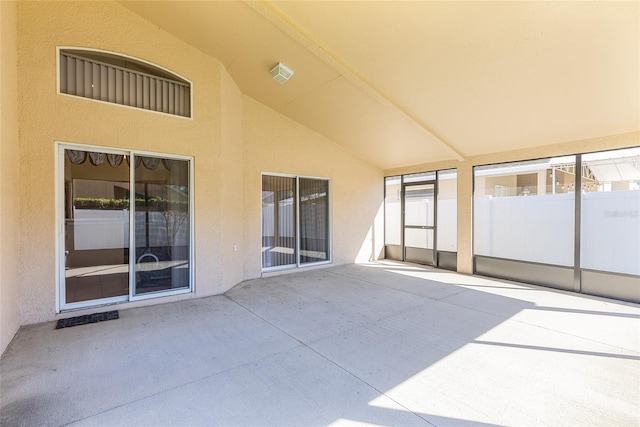 unfurnished sunroom with vaulted ceiling