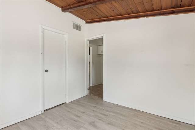 unfurnished bedroom featuring visible vents, lofted ceiling with beams, wood ceiling, and light wood-type flooring