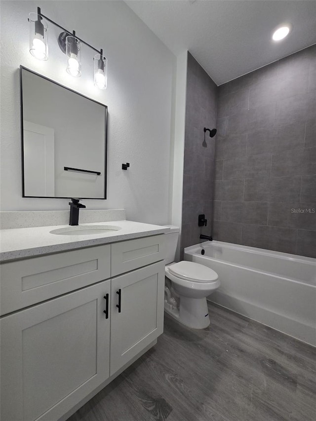 full bathroom with shower / tub combination, vanity, toilet, and wood finished floors