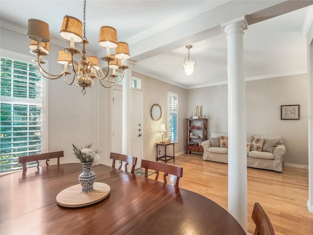 dining space with light wood-style flooring, baseboards, ornamental molding, decorative columns, and an inviting chandelier