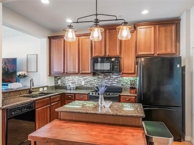 kitchen featuring dark stone counters, black appliances, backsplash, and a sink