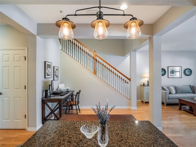 interior space with stairway, light wood-style flooring, and baseboards