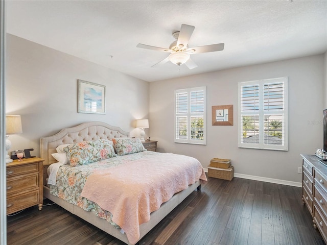 bedroom featuring ceiling fan, dark wood-style flooring, multiple windows, and baseboards