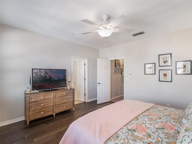 bedroom with baseboards, visible vents, dark wood finished floors, and a ceiling fan