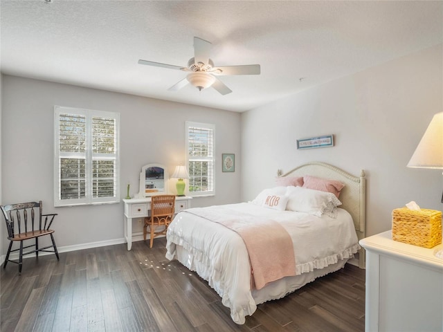 bedroom featuring dark wood-style flooring, ceiling fan, and baseboards