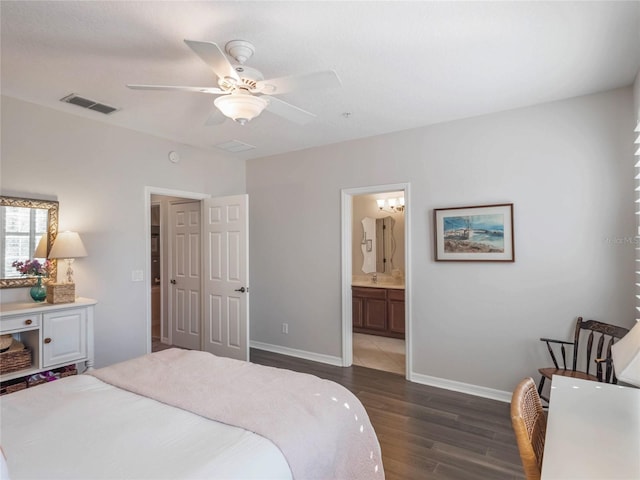 bedroom with baseboards, visible vents, connected bathroom, dark wood-style floors, and ceiling fan