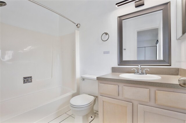 full bath with bathing tub / shower combination, vanity, toilet, and tile patterned floors