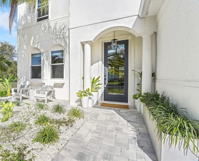 property entrance with stucco siding