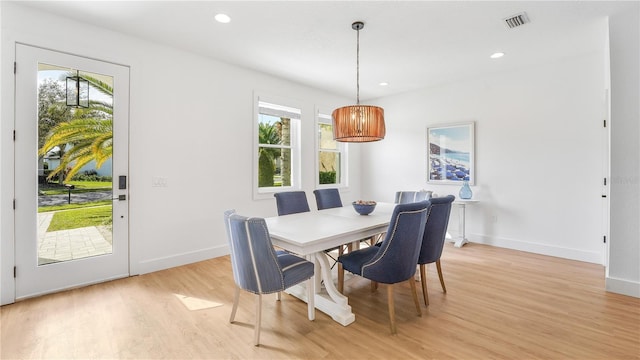 dining room featuring light wood-type flooring, visible vents, baseboards, and recessed lighting