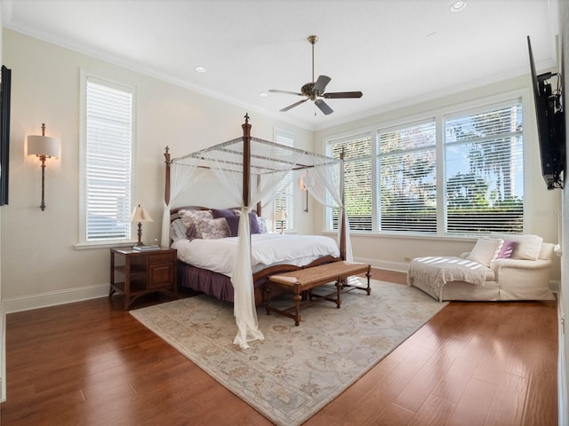 bedroom with baseboards, ceiling fan, wood finished floors, crown molding, and recessed lighting