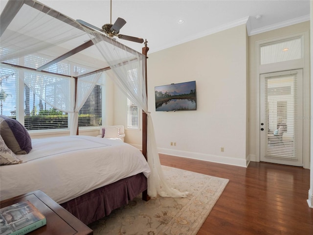 bedroom with ornamental molding, a ceiling fan, baseboards, and wood finished floors