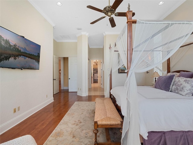 bedroom with ornamental molding, wood finished floors, a ceiling fan, and baseboards