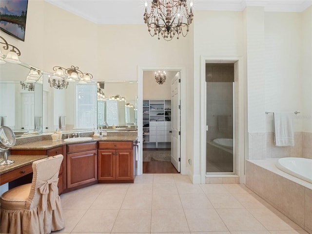 full bath with a stall shower, ornamental molding, tile patterned floors, an inviting chandelier, and a garden tub