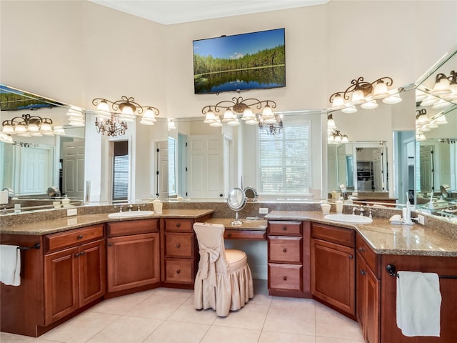 bathroom with two vanities, a sink, a towering ceiling, and tile patterned floors