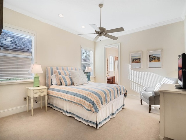 carpeted bedroom with crown molding, baseboards, and ceiling fan