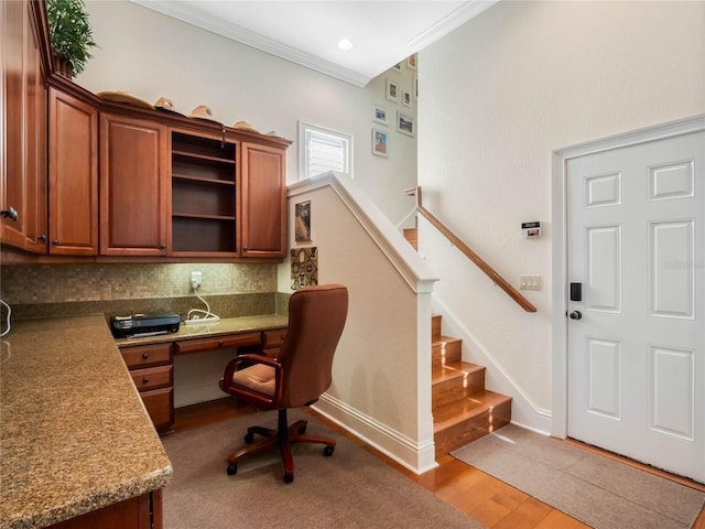 office area featuring baseboards, crown molding, and wood finished floors