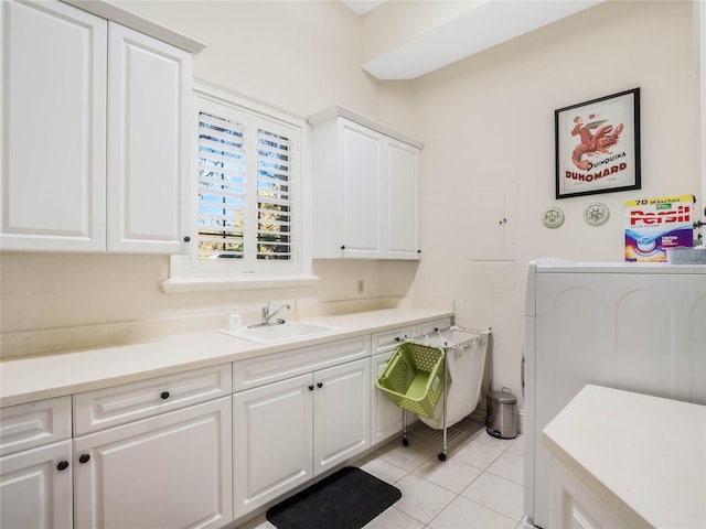 clothes washing area with washer / dryer, cabinet space, a sink, and light tile patterned floors