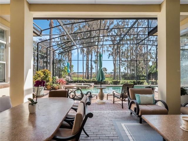 view of patio featuring a pool with connected hot tub, glass enclosure, and outdoor dining area