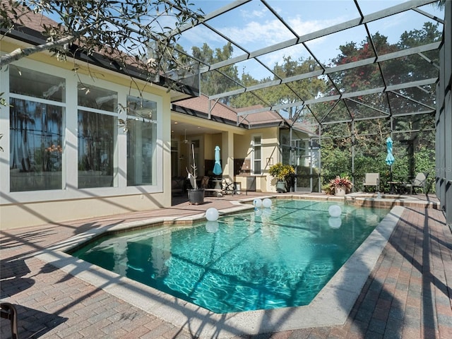 view of swimming pool with a patio area, a lanai, and a pool with connected hot tub