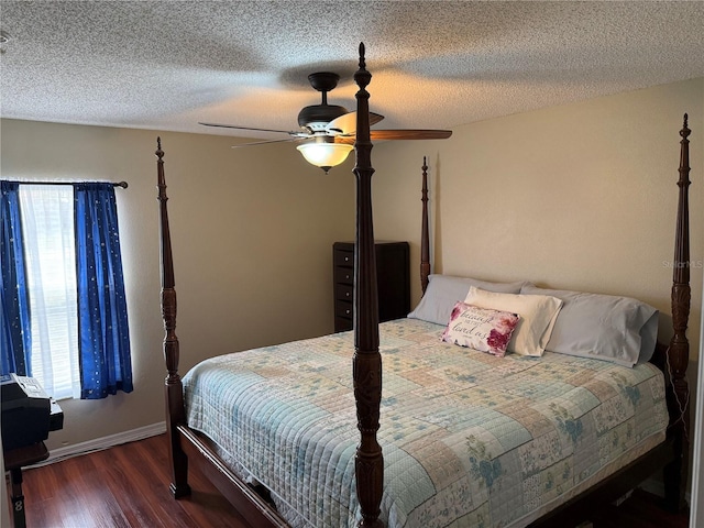 bedroom featuring a ceiling fan, a textured ceiling, baseboards, and wood finished floors