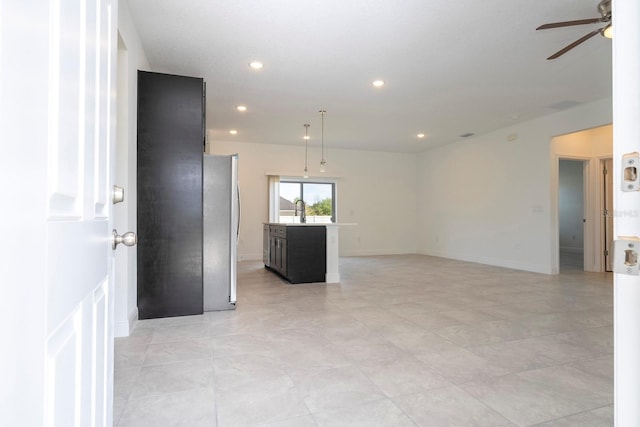 spare room featuring baseboards, a sink, a ceiling fan, and recessed lighting