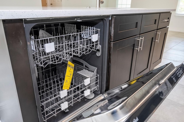 interior details featuring dishwashing machine and light stone counters