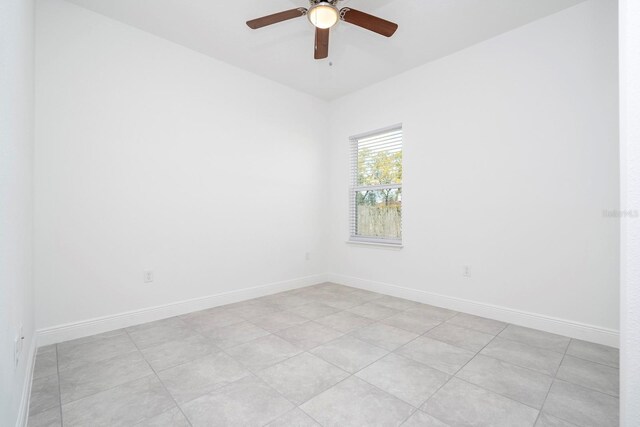 unfurnished room featuring a ceiling fan and baseboards