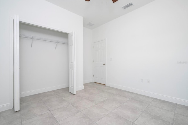 unfurnished bedroom with a ceiling fan, baseboards, visible vents, and a closet