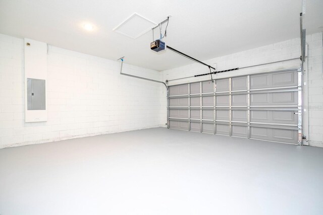 garage featuring a garage door opener and electric panel