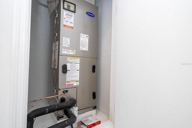 utility room featuring heating unit