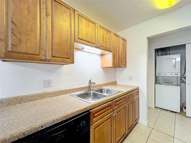 kitchen featuring light tile patterned flooring, stacked washer and dryer, a sink, brown cabinets, and dishwasher