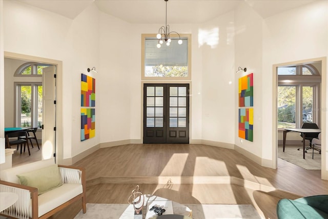 interior space featuring a wealth of natural light, french doors, and a high ceiling