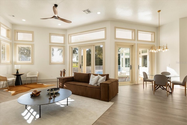 living area featuring ceiling fan, recessed lighting, wood finished floors, visible vents, and baseboards