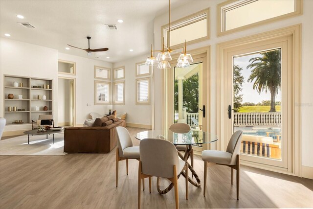 dining room with baseboards, light wood finished floors, visible vents, and recessed lighting