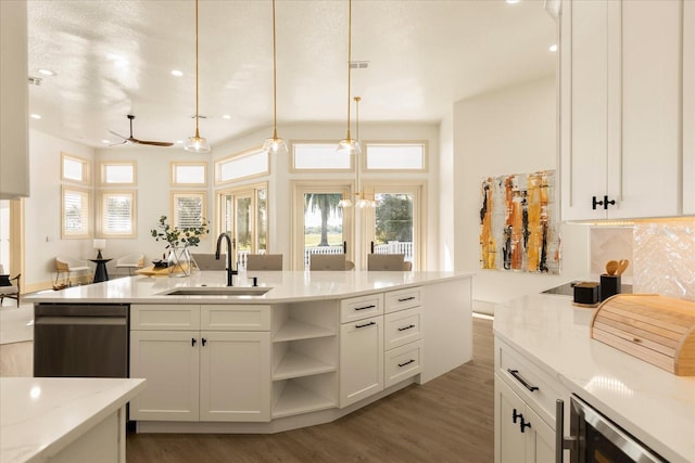 kitchen with stainless steel dishwasher, a sink, white cabinets, and light wood-style floors