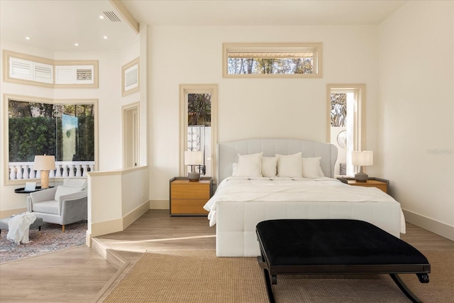 bedroom with light wood-type flooring, visible vents, baseboards, and recessed lighting