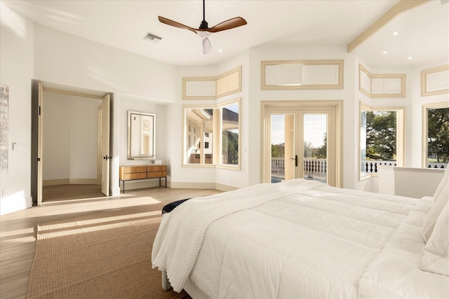 bedroom with access to exterior, french doors, visible vents, wood finished floors, and baseboards