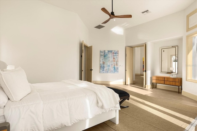 bedroom with a ceiling fan, visible vents, and baseboards