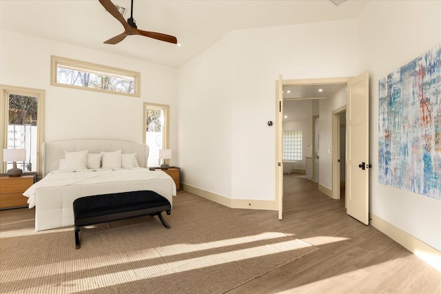 bedroom with a ceiling fan, baseboards, and wood finished floors