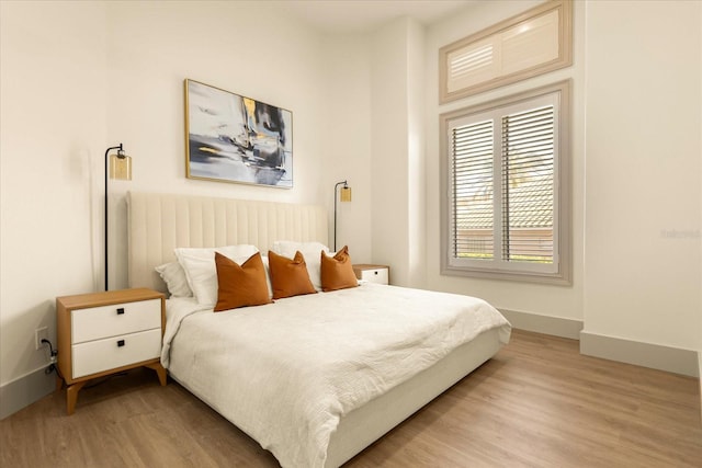 bedroom featuring light wood-style flooring and baseboards