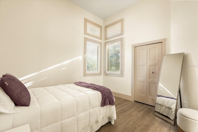 bedroom featuring wood finished floors and baseboards