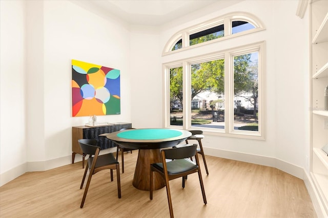 game room with light wood finished floors and baseboards