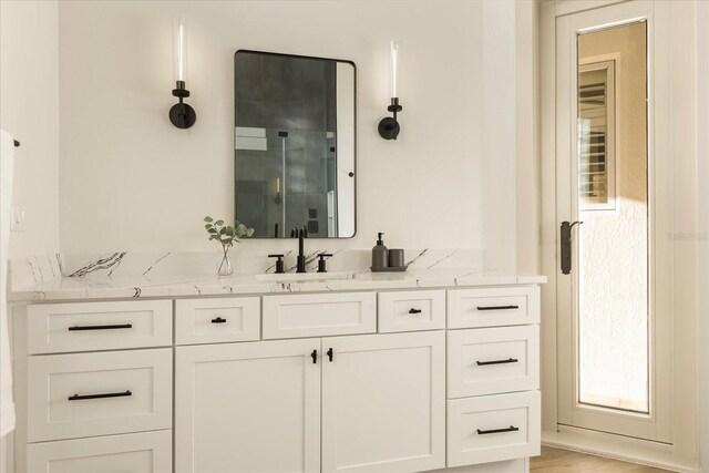 full bathroom with a stall shower and vanity