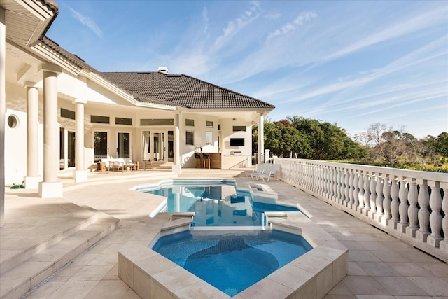 view of pool featuring a fenced in pool, a patio, and an in ground hot tub