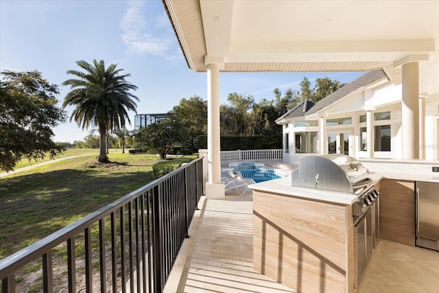 exterior space featuring grilling area and exterior kitchen