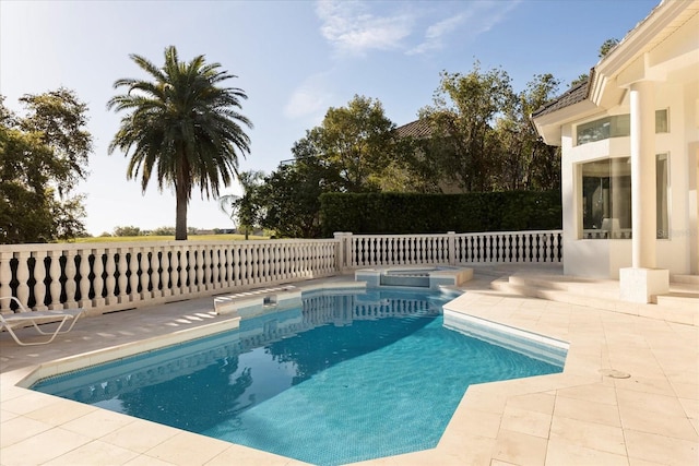 view of swimming pool with a patio area and a pool with connected hot tub