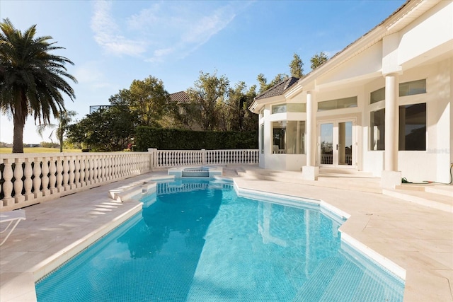 view of pool featuring a fenced in pool, french doors, and a patio area