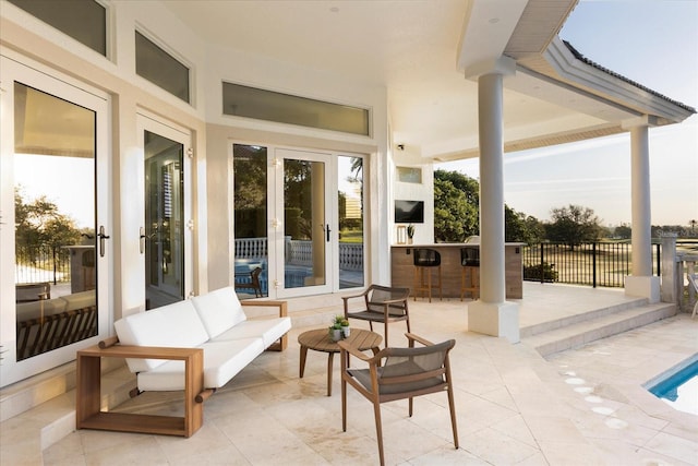 view of patio / terrace featuring outdoor dry bar, french doors, and outdoor lounge area