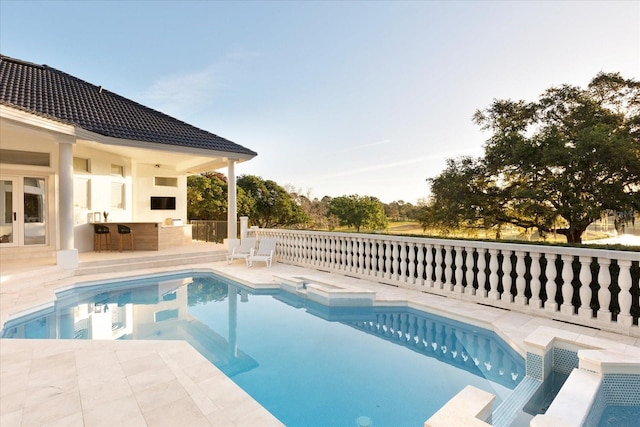 view of swimming pool featuring outdoor dry bar, a fenced in pool, and a patio