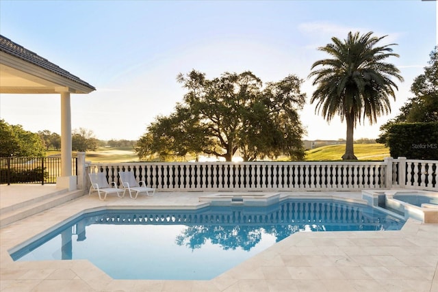 view of swimming pool featuring a pool with connected hot tub